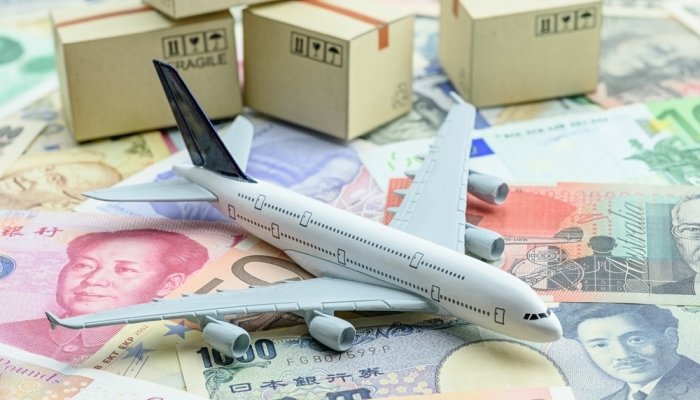 White Model Airplane Lands On Banknotes