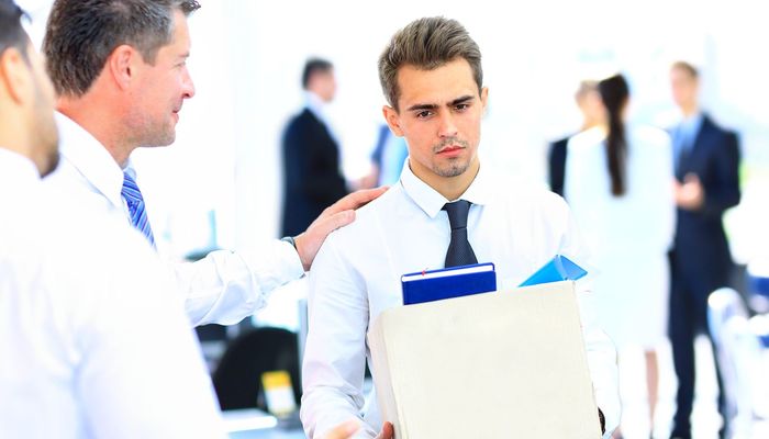 Man leaving the office after being fired