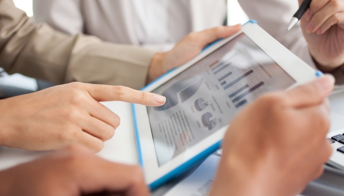 Professional consultant using tablet to show data
