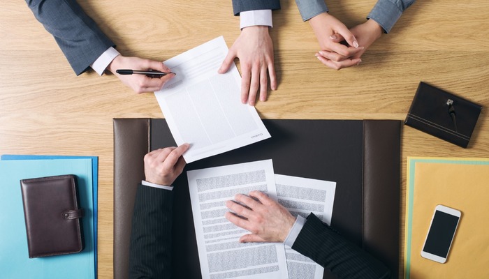 Lawyer going through legal documents with business clients