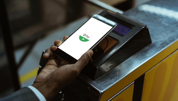 Person using Google Pay at a payment scanner