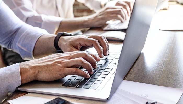 Man typing on laptop in office