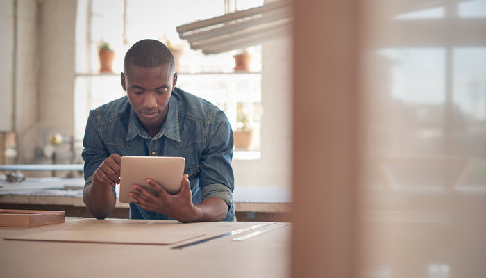 Young man using tablet device in a workshop