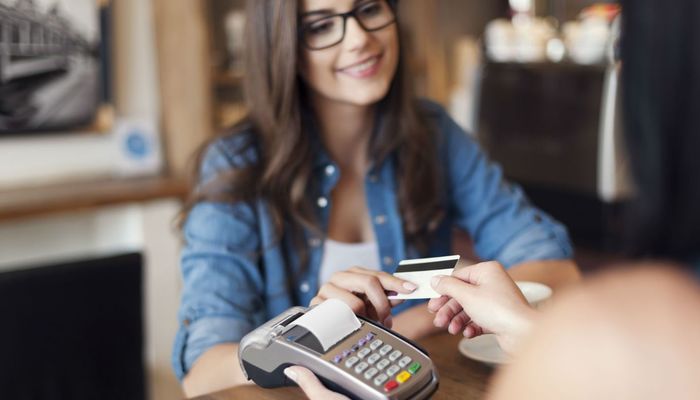 Woman using a loyalty card while shopping