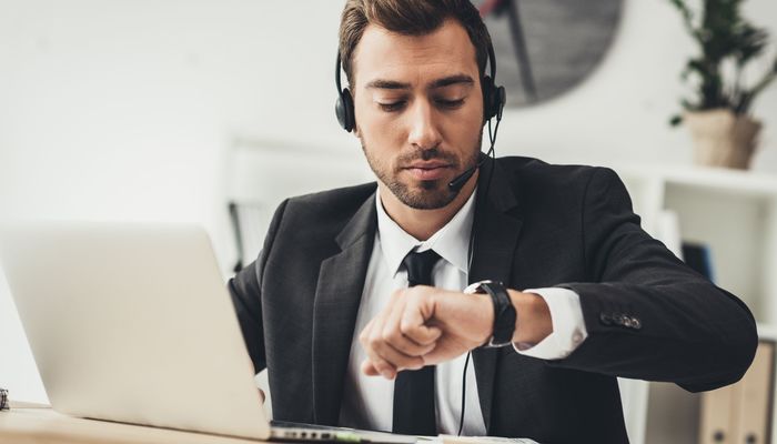 Businessman at work looking at his watch
