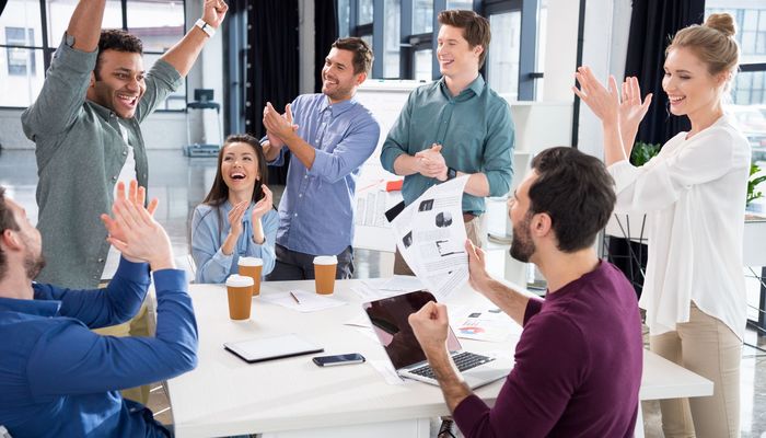 Business team celebrating success together on workplace in incubator