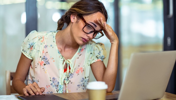 Frustrated entrepreneur staring at her laptop