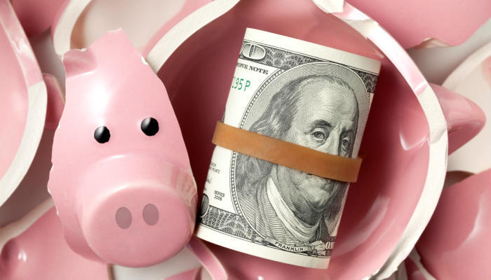 Savings. Broken Piggy Bank With Dollars Banknotes